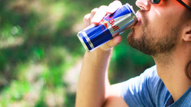 Man drinking red bull