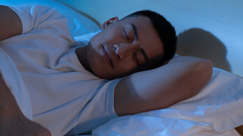 Young man asleep in bed