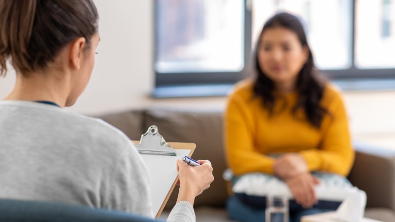 A therapist speaks with a patient