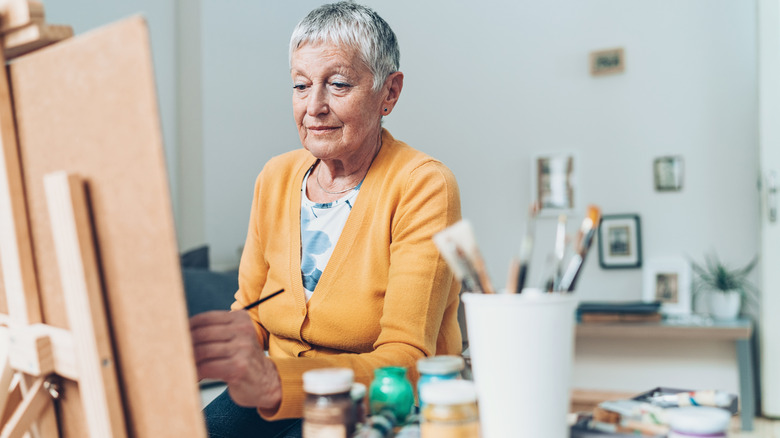 older left-handed woman painting 