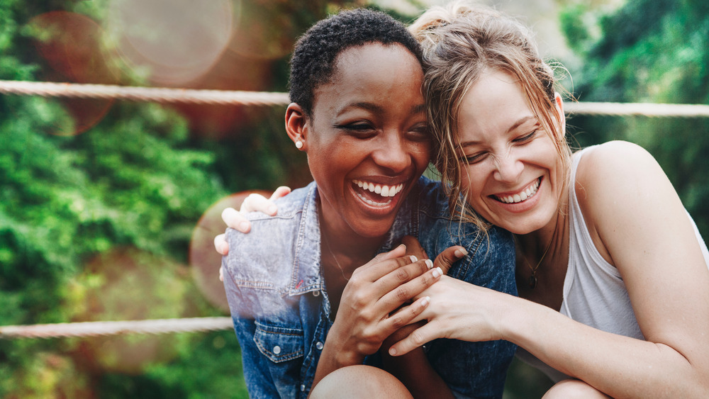 women hugging and smiling