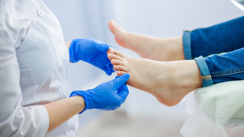 a doctor looking at feet