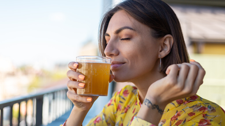 woman drinking kombucha