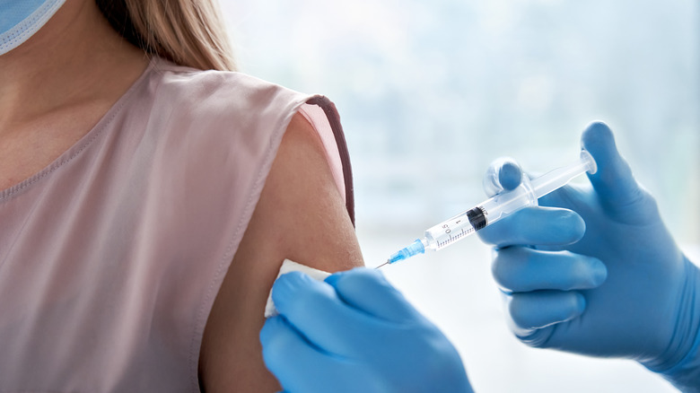 Vaccine injection into woman's arm