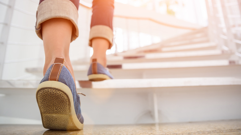 close up of woman's feet climbing stairs