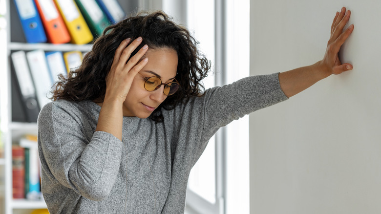 woman feeling dizzy after standing up