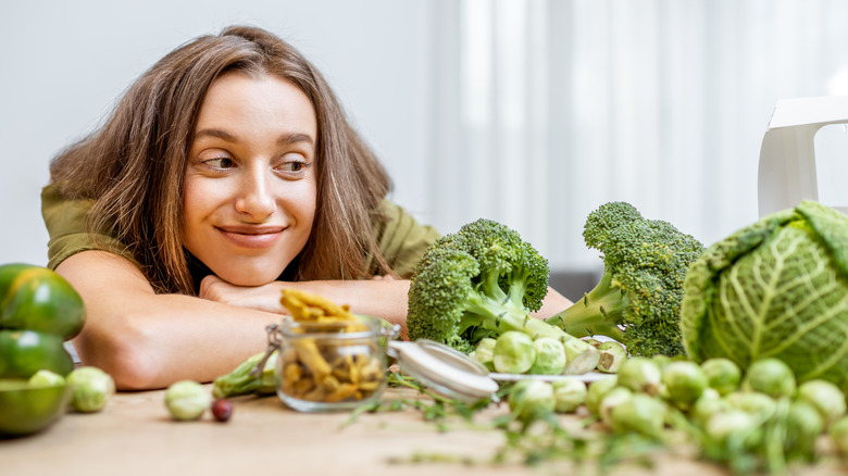 woman looking at cruciferous vegetables