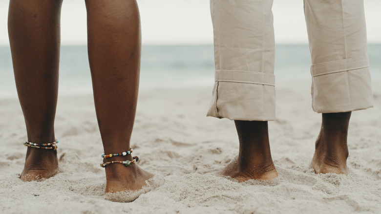 Bare feet standing in sand