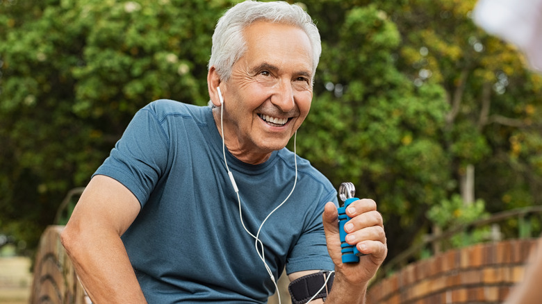 Smiling man squeezing handgrip device