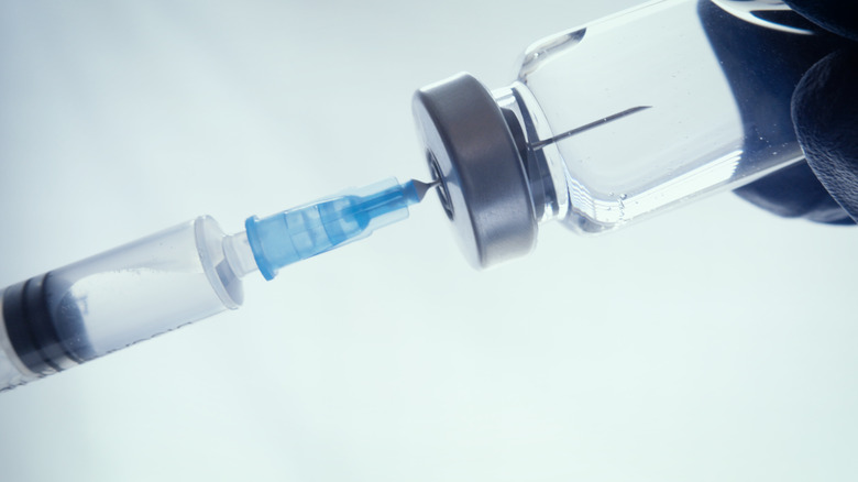 Closeup of a doctor filling a syringe with vaccine