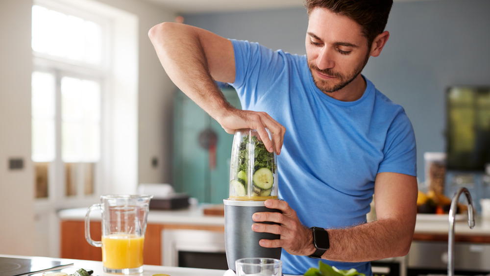 A man blending a post-workout smoothie 