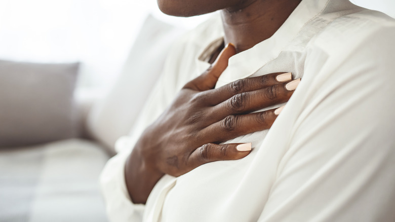 Person with hand on chest breathing deeply
