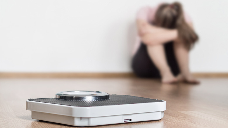 woman frustrated with weight scale