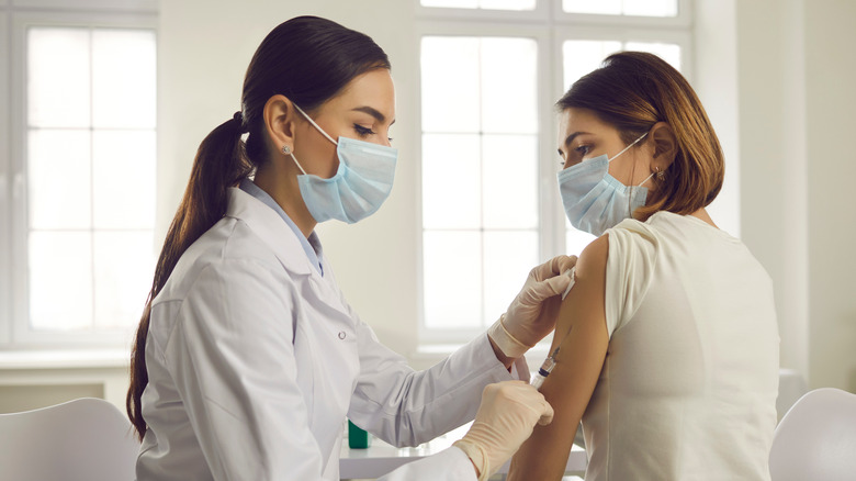 A medical provider giving a vaccine injection to a patient