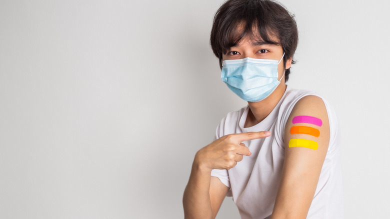 Man with three bandaids on arm