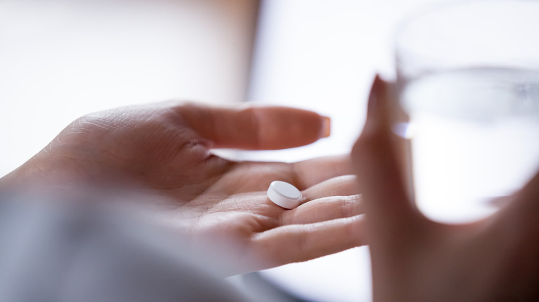 woman about to take pill