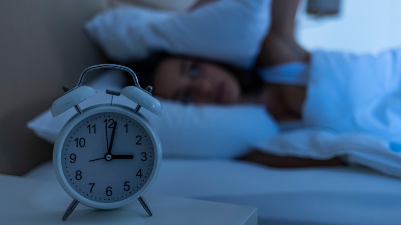 woman awake with clock