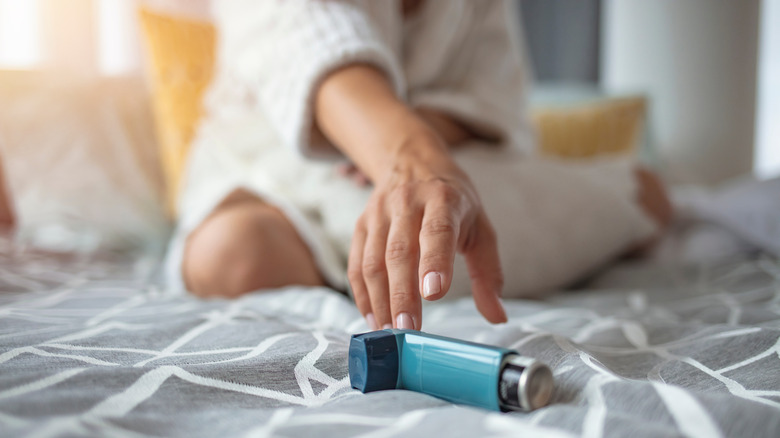 Woman reaching for inhaler