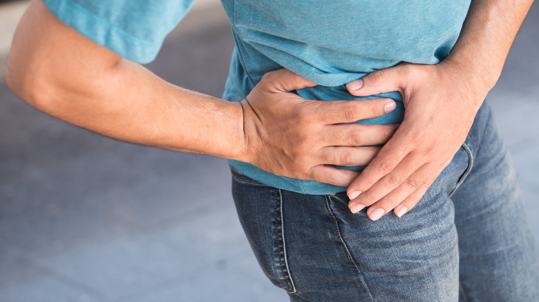 woman holding pelvic area