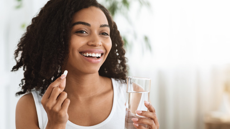 Woman taking a biotin supplement