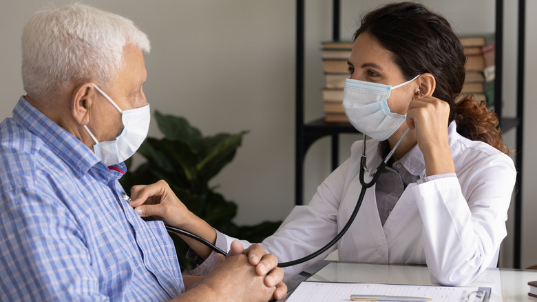 Doctor giving patient a heart check up