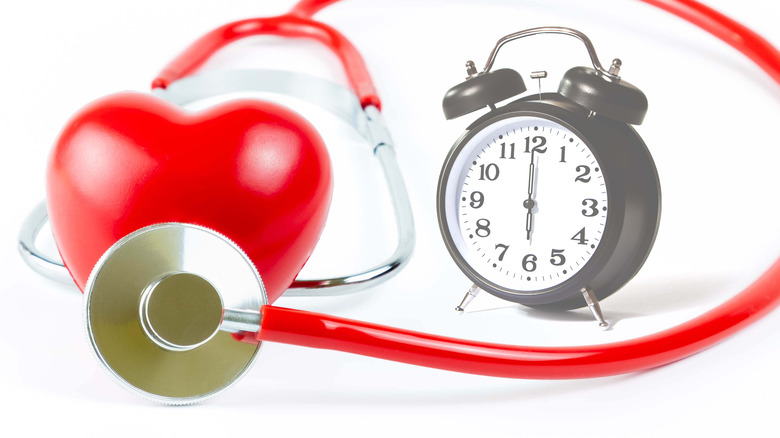 Heart with stethoscope and alarm clock