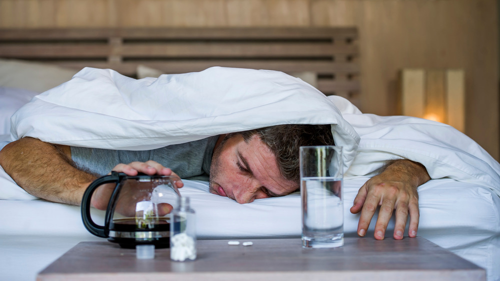 Man hungover with coffee and water