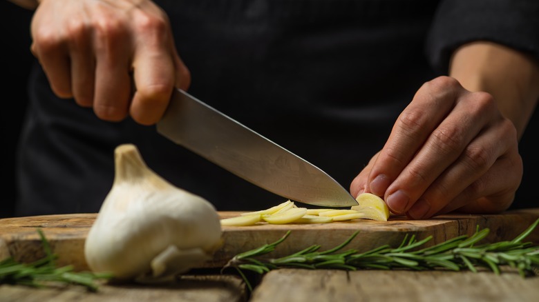 Man cutting garlic