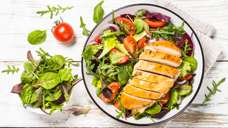 healthy salad with chicken on table