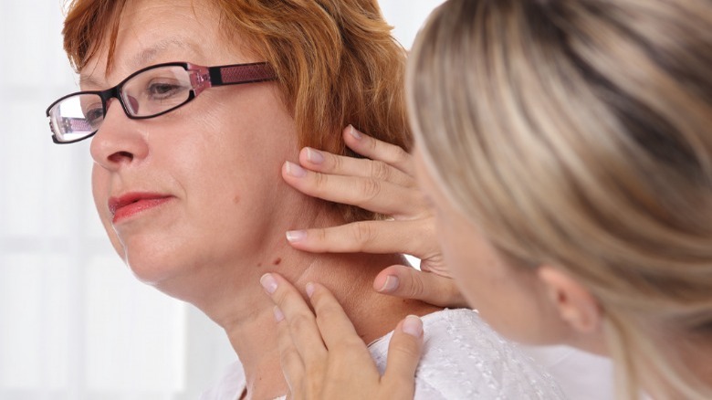 dermatologist examinines patient's neck