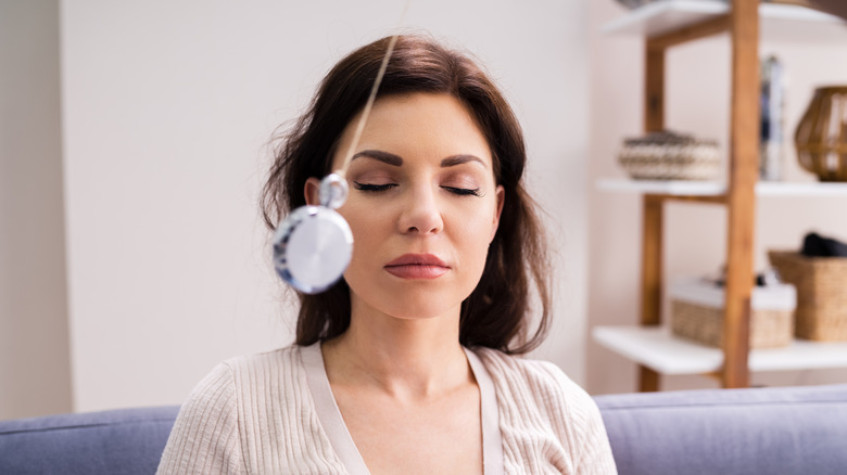 Woman with eyes closed in hypnotherapy