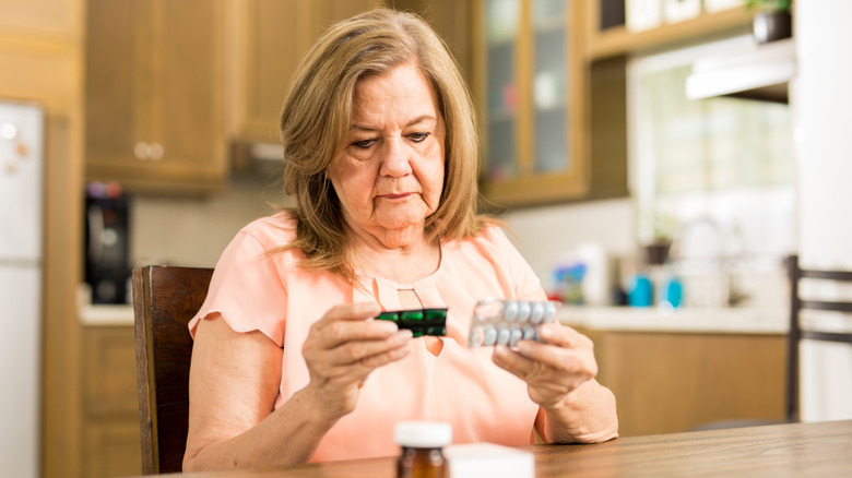 woman checking drug expiration dates