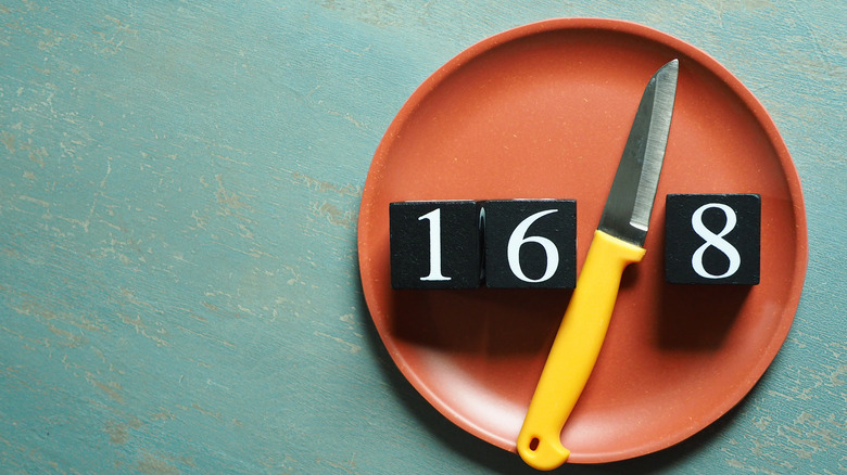 fasting concept with plate, numbers, knife