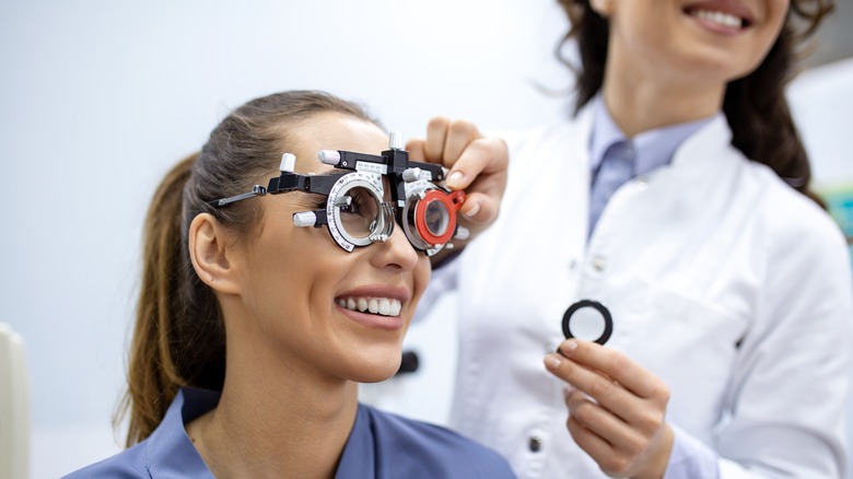 doctor checking patient's eyes