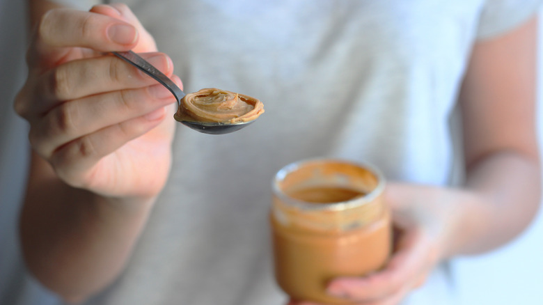 Eating spoonful of peanut butter
