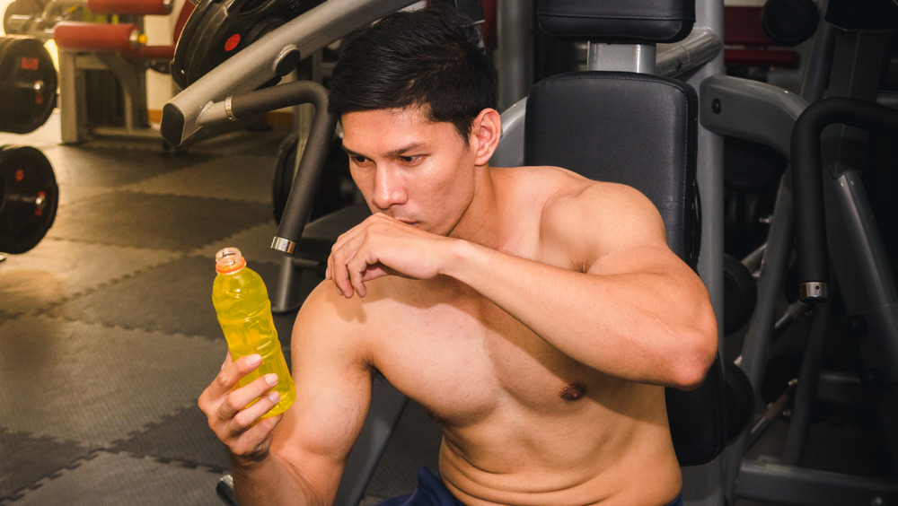 Man working out drinking electrolytes