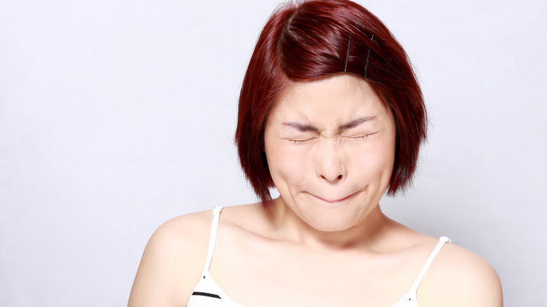 Woman making a sour facial expression