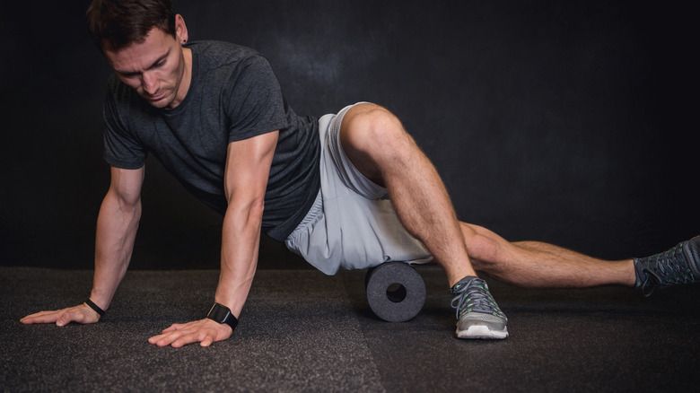 man using foam roller