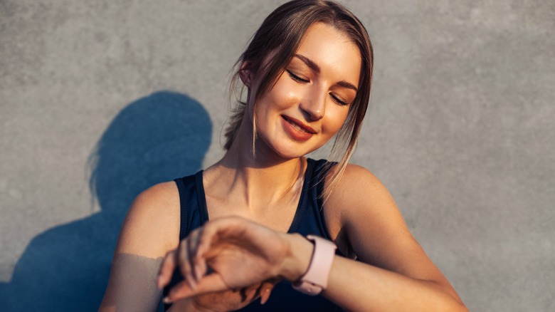 Woman looking at fitness tracker