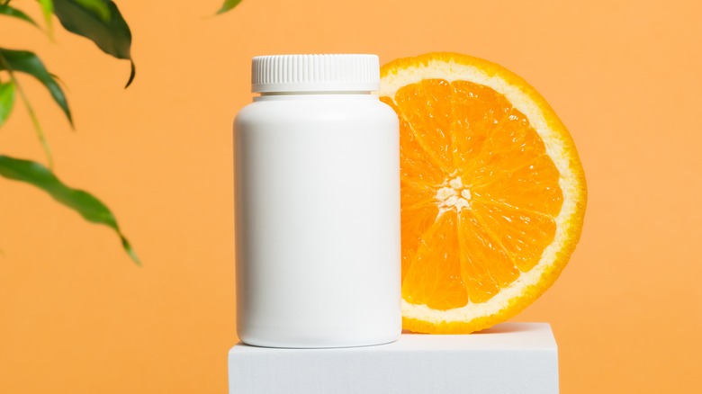 Orange slice next to pill bottle