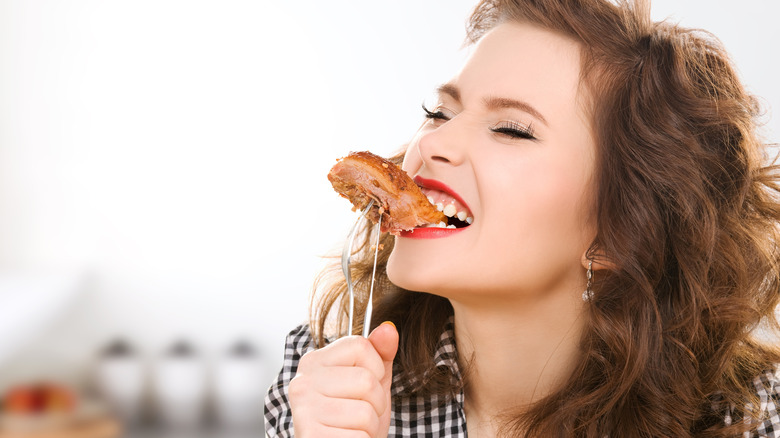 Happy person eating pork