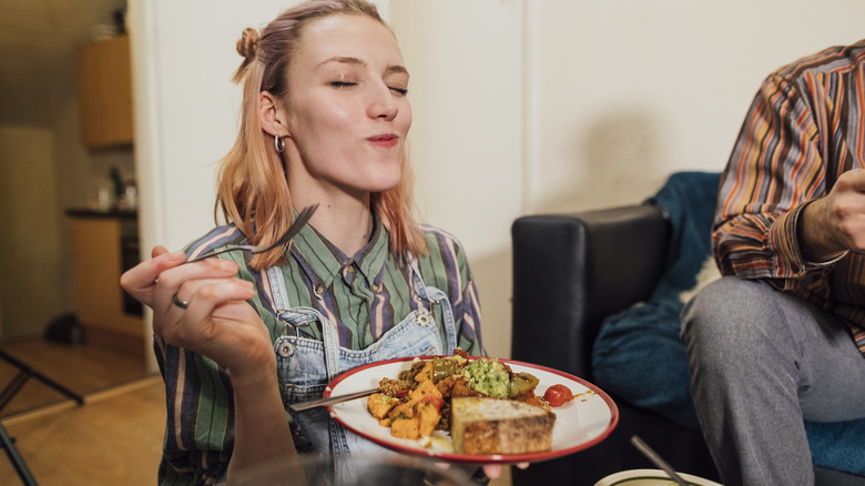 Woman eating a vegan dish