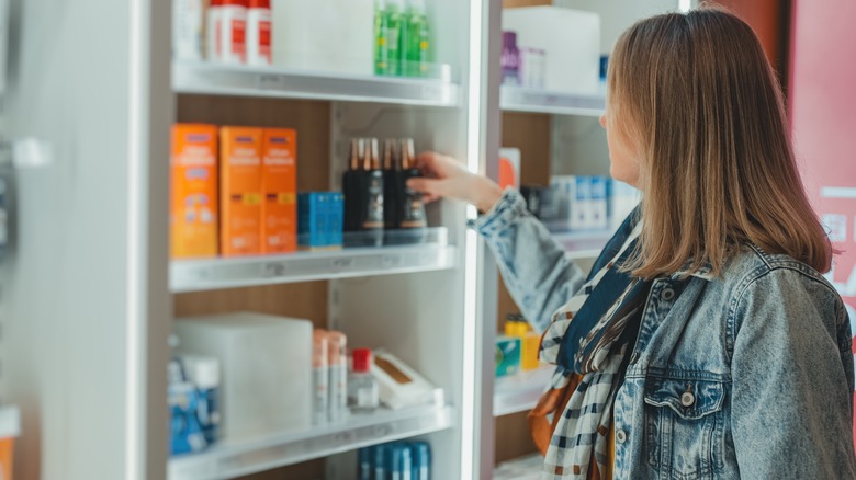 woman choosing supplement in store