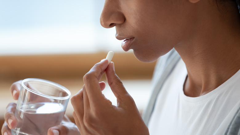 Woman taking a pill