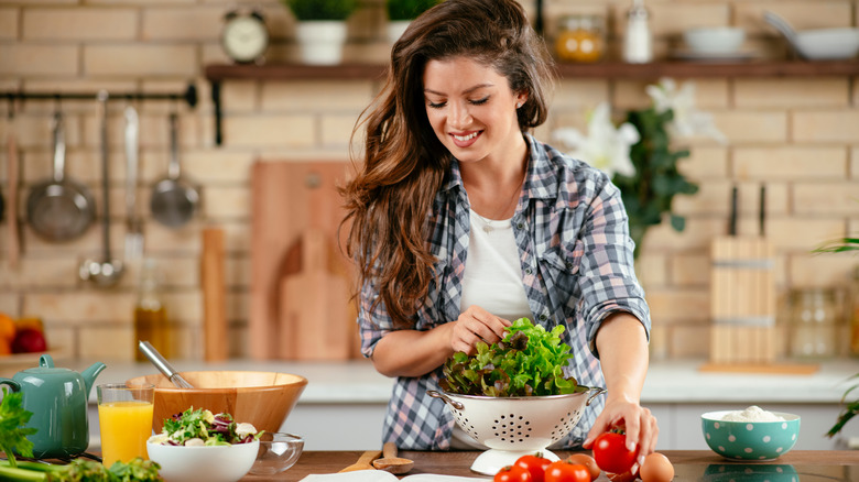 A woman prepares healthy food in the kitchen