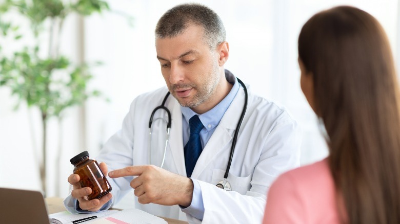 doctor and patient discussing pill bottle