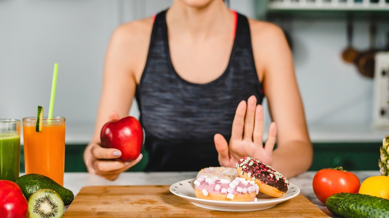 A woman saying no to sugar and yes to healthy food