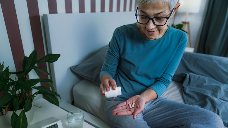 A woman taking her medication before bed