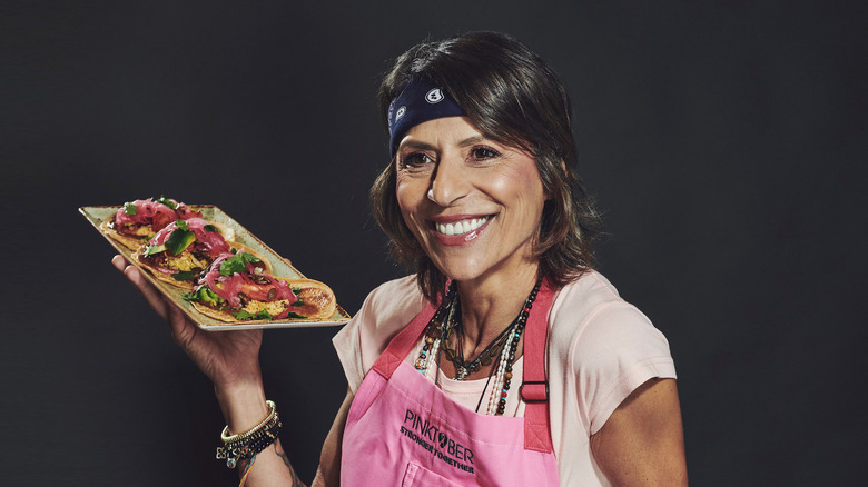 Dominique Crenn holding plate of food