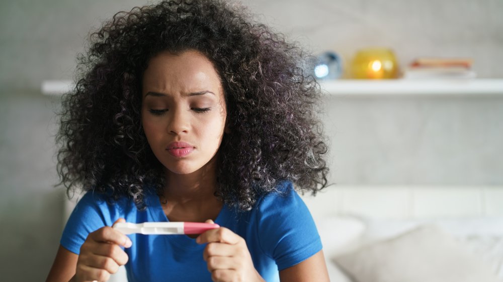 woman inspecting pregnancy test